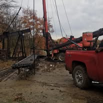 Service trucks and rig equipment at an oilfield site